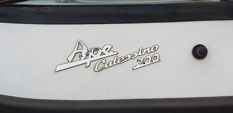 Chrome script reading Ape Calessino 200 on a white panel, a black rubber trim above and below. Opens a larger view