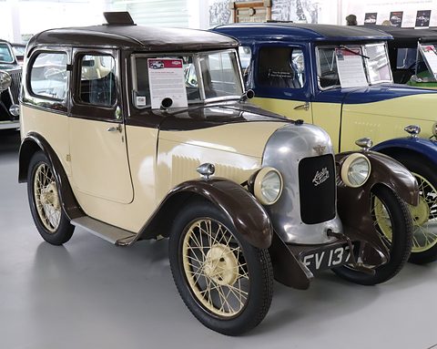 A cream saloon with a brown roof and wings, a polished radiator cowl and wire wheels. Opens a larger view