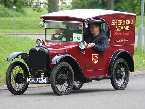 A maroon van lettered Shepherd Neame Faversham with black wings and wire wheels, its driver leaning out. Opens a larger view