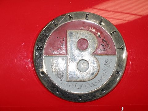 Round enamel badge with a large B and the word Berkeley on red paint. Opens a larger view