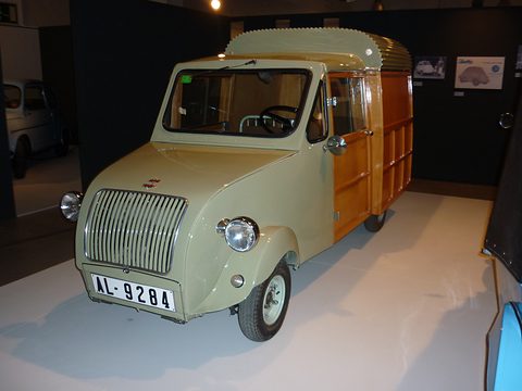 Pale green small van with a vertical-bar grille and a wooden box body taller than the cab, plate AL-9284. Opens a larger view