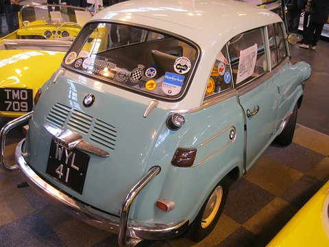 Rear of a pale blue car with white roof, club stickers in the back window and a black WYL 41 plate. Opens a larger view
