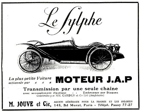 A printed advertisement: a low single-seat cyclecar with wire wheels and a rear engine beneath ornate script lettering. Opens a larger view