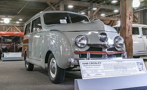 Front of a grey small estate with a three-lamp bull-nose grille and a placard reading 1948 CROSLEY. Opens a larger view