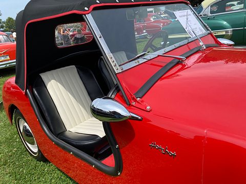 Red flank with a cut-down cockpit opening, white pleated seat, a chrome mirror and Hotshot script. Opens a larger view