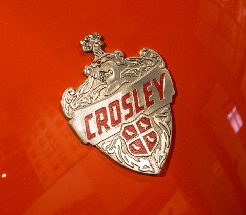 Silver and red shield badge reading CROSLEY on glossy orange paint. Opens a larger view