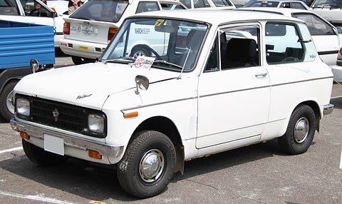 White boxy two-door saloon with a black grille, rectangular headlamps and a wing mirror on the front wing.