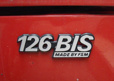 Chrome and black badge reading 126 BIS above MADE BY FSM on red paint. Opens a larger view