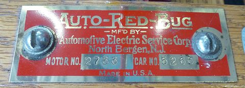 A red and brass plate reading Auto-Red-Bug, Automotive Electric Service Corp., North Bergen, N.J., with motor and car numbers. Opens a larger view