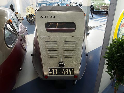 Dimpled aluminium tail with louvres, a small rear window, the word ANTON and plate FW 13-4841. Opens a larger view