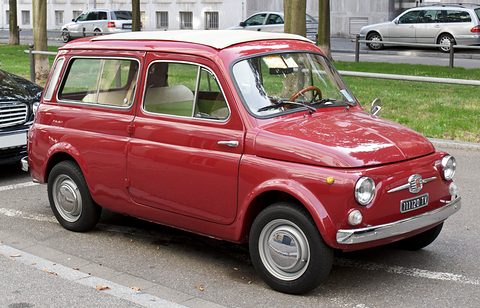 Dark red small estate car with a cream roof and chrome bumpers parked at a kerb beside grass. Opens a larger view