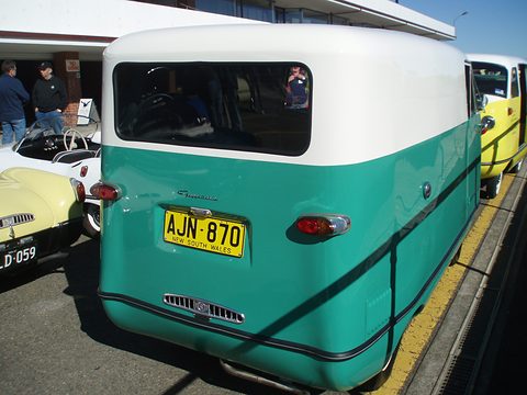 Teal and white van seen from the rear left with a New South Wales number plate. Opens a larger view