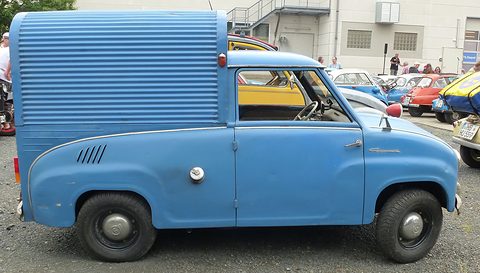 Side view of a blue van with a saloon cab and a tall corrugated box behind it. Opens a larger view