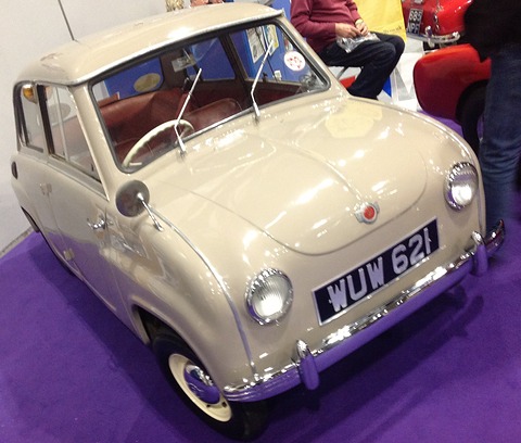 Beige saloon with a red interior on a purple show carpet, seen from the front left. Opens a larger view
