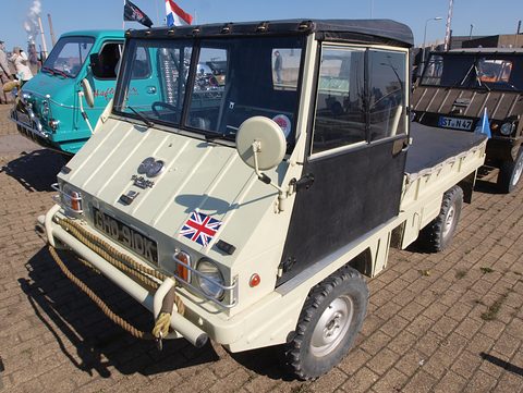 Cream small 4x4 with a black canvas cab, a winch rope and a Union flag sticker. Opens a larger view