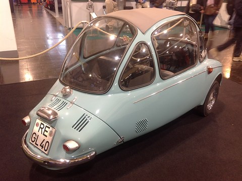 Pale blue bubble car from behind with a louvred tail and a German number plate, on dark carpet. Opens a larger view