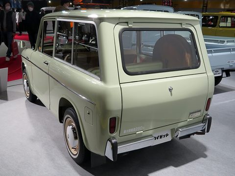 Rear of a pale green small estate van with a side-hinged tailgate and a Hijet badge. Opens a larger view