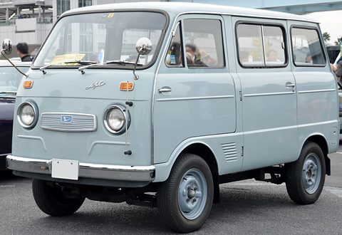 Pale blue small cab-over van with round headlamps and a ‘Hijet Cab’ script in a car park. Opens a larger view