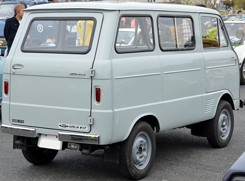 Rear of a pale blue small van with a tailgate and a Japanese script badge in a car park. Opens a larger view