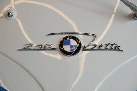 Chrome script reading 250 Isetta around a blue and white BMW roundel on white paint. Opens a larger view