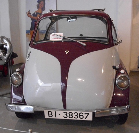 Front of a maroon and white bubble car, the whole nose a door with a central handle, Spanish plate BI 38367. Opens a larger view