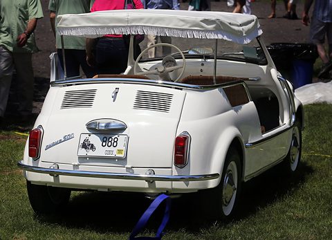 Rear of a white open Fiat 500 with a louvred engine lid, a fringed awning and a custom plate reading 888. Opens a larger view
