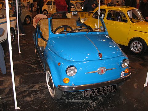Light blue doorless Fiat 500 with wicker seats and a British plate, seen from the front, a yellow Fiat 500 behind. Opens a larger view