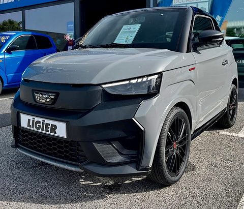 Grey angular microcar with a black front panel, slim LED lamps, a LIGIER plate and large black alloy wheels.