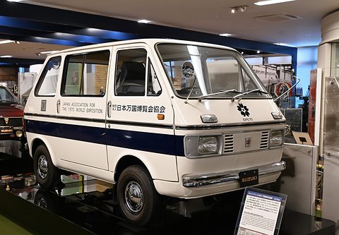 White van with a navy stripe and Japan Expo association lettering on a museum display. Opens a larger view