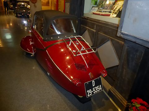 Red tapering tail with a chrome luggage rack and plate D 29-5354 in a narrow display. Opens a larger view