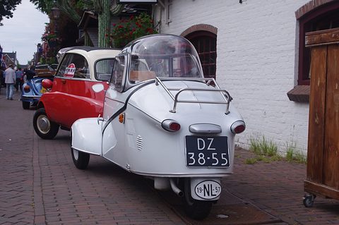 White tapering tail with chrome rack and plate DZ-38-55 on a brick street.