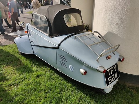 Pale blue tail with chrome rack and registration TPY 584 beside a white wall. Opens a larger view