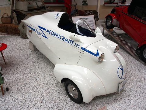 White streamlined single-seater with a blue Super Messerschmitt 200 stripe on a gravel display.