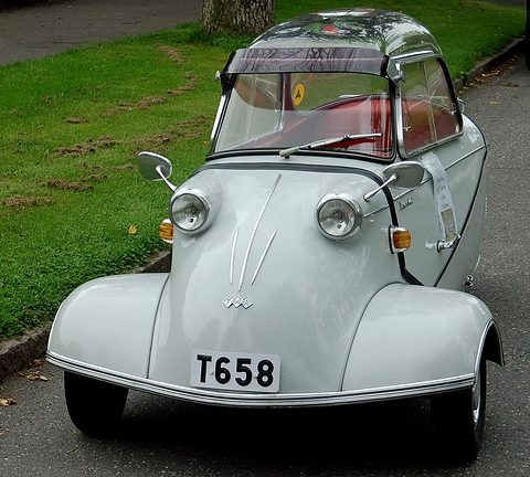 Silver-grey bubble car facing the camera with registration T658, grass behind. Opens a larger view