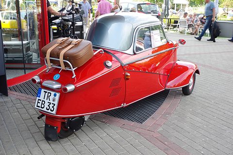 Red tapering tail with a brown leather suitcase strapped to the chrome rack. Opens a larger view