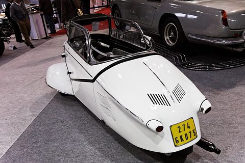 White tapering tail with louvres and twin exhausts, a yellow French number plate, grey carpet. Opens a larger view