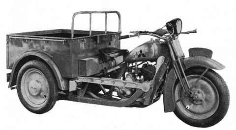 Black and white side view of a three-wheeled truck with a load rail on the front of its cargo box. Opens a larger view
