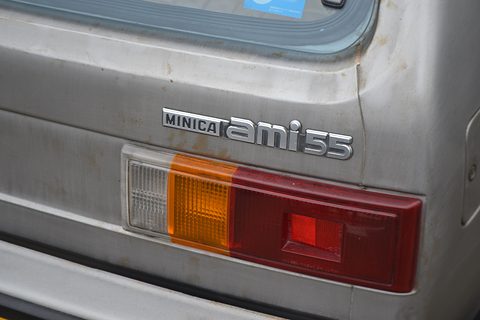 Close view of a silver tail with chrome MINICA ami55 lettering above a red and amber lamp. Opens a larger view