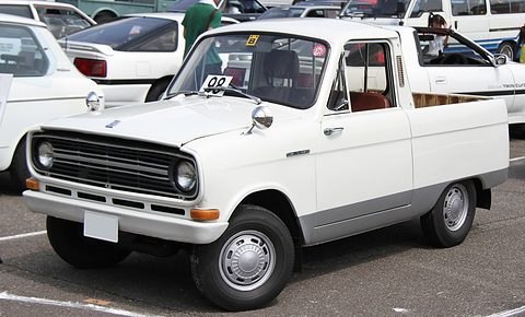 White small pickup with a chrome grille, parked among white cars. Opens a larger view