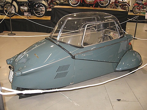 Blue-grey tapering tail with louvres and a Mivalino script, rope barrier around it. Opens a larger view