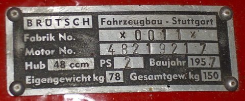 Aluminium plate stamped BRÜTSCH Fahrzeugbau Stuttgart with factory and engine numbers, on red paint. Opens a larger view