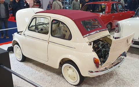 Cream Fiat 500 with a maroon fabric roof and its rear lid raised to show the upright twin-cylinder engine.