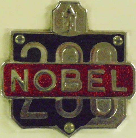 Red enamelled NOBEL lettering across a chrome 200 emblem on cream paintwork. Opens a larger view