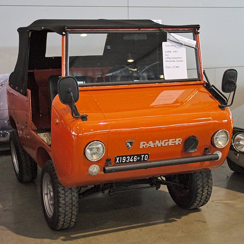 Orange miniature off-roader with a black soft top, RANGER lettering and Italian plates, a sale card in its windscreen. Opens a larger view