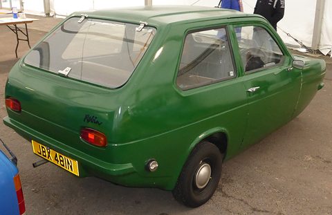 Green hatchback from behind, showing the rear lamps, Robin script and a yellow number plate. Opens a larger view