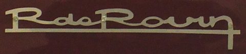 A chrome script badge reading R de Rovin with a long underline on a dark maroon paint background. Opens a larger view