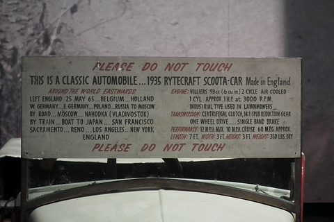 Hand-lettered board listing the route from England through Europe, Russia, Japan and the United States, with engine details.