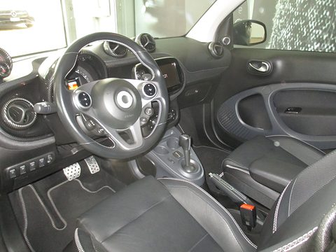 Black and silver steering wheel with paddles, round dashboard pods, perforated leather seats and alloy pedals. Opens a larger view