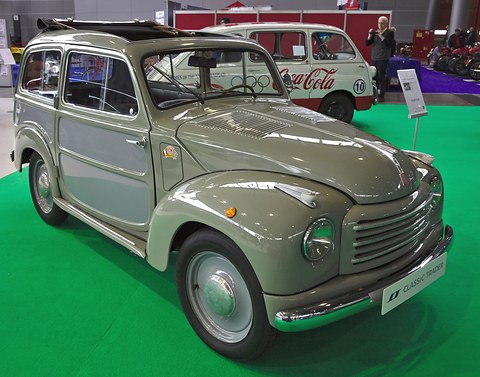 Grey small estate with pressed-steel sides painted in a lighter panel colour, on green show carpet. Opens a larger view