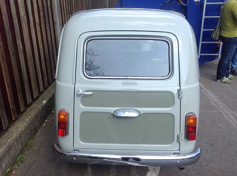 Pale green small estate from directly behind, a side-hinged rear door with a window. Opens a larger view